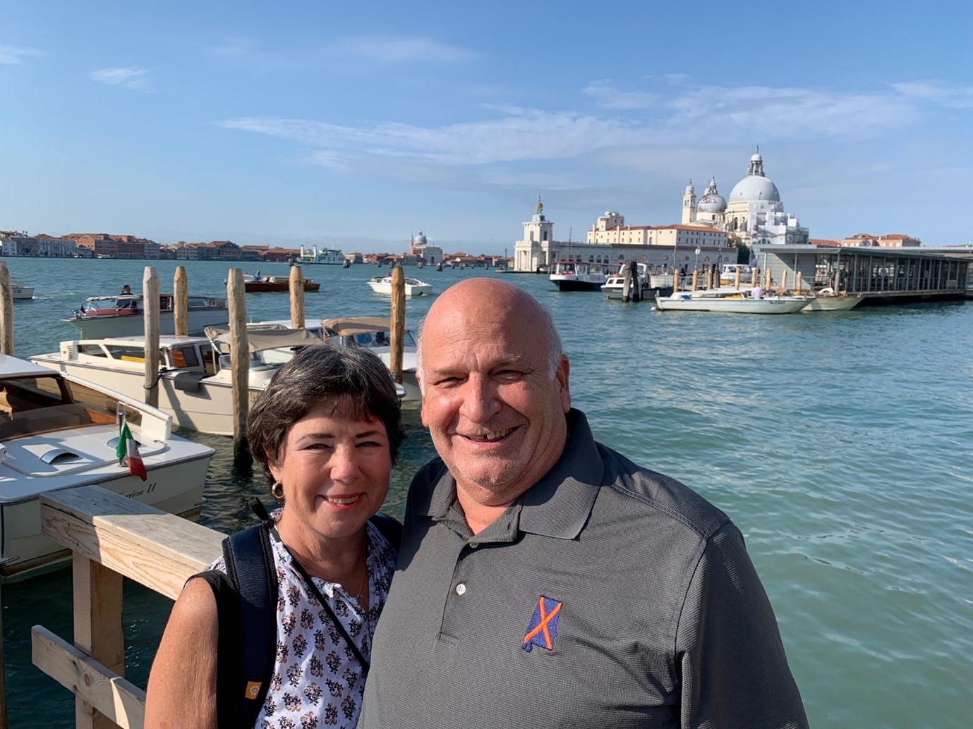Couple standing by the canal in Venice